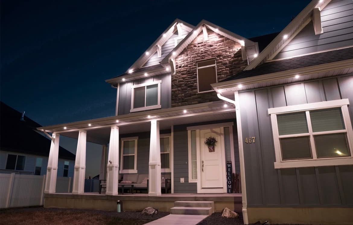 Completed home installation with warm white scene and clean roofline.