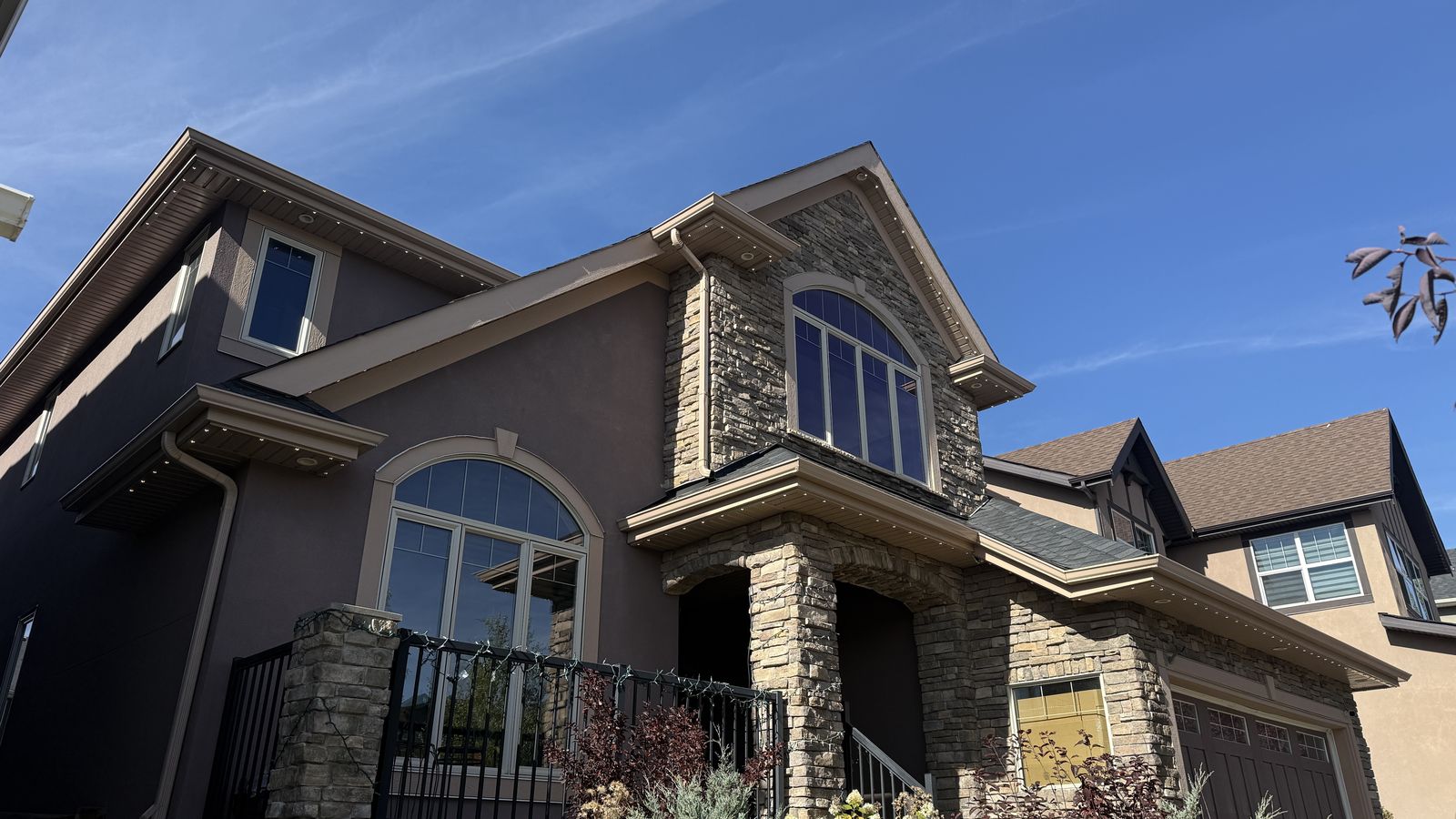 Luminair permanent lights on a Calgary home during the day, the track nearly invisible in the soffit